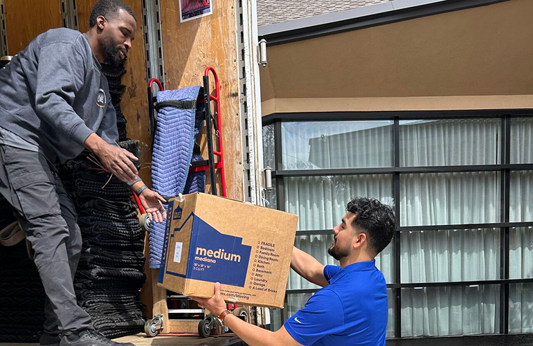 2 men unloading moving truck