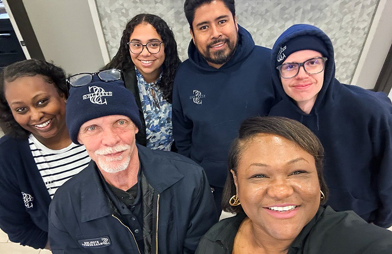 6 people standing together smiling
