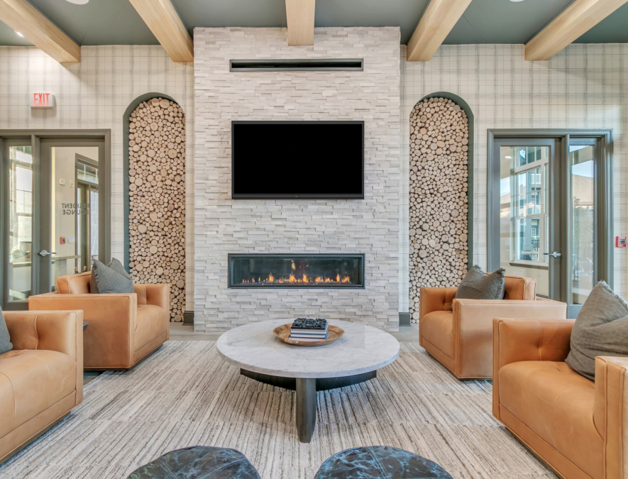 The Sterling Group interior of 4 orange seats around fireplace